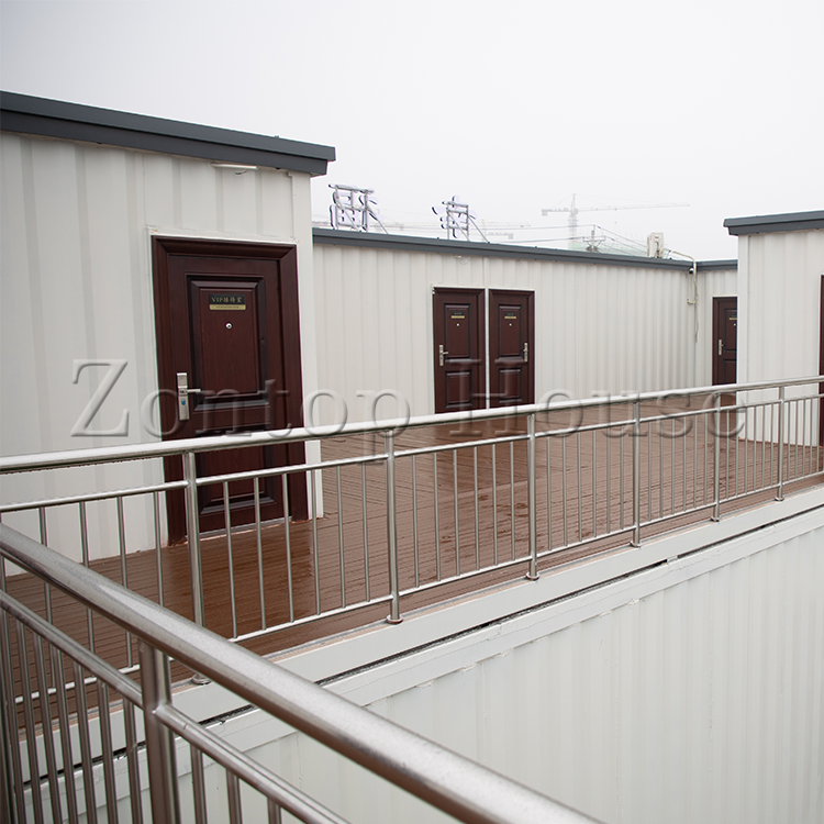 the-model-6-features-an-offset-layout-the-main-entrance-is-recessed-and-a-small-hallway-leads-to-the-bathroom-and-two-bedrooms-the-kitchen-is-open-to-the-living-and-dining-space.png the-model-6-features-an-offset-layout-the-main-entrance-is-recessed-and-a-small-hallway-leads-to-the-bathroom-and-two-bedrooms-the-kitchen-is-open-to-the-living-and-dining-space.png